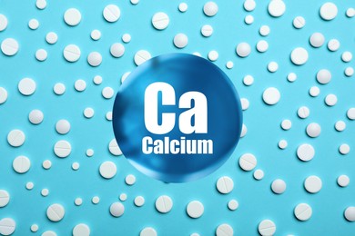 Image of Calcium supplement pills on turquoise background, flat lay