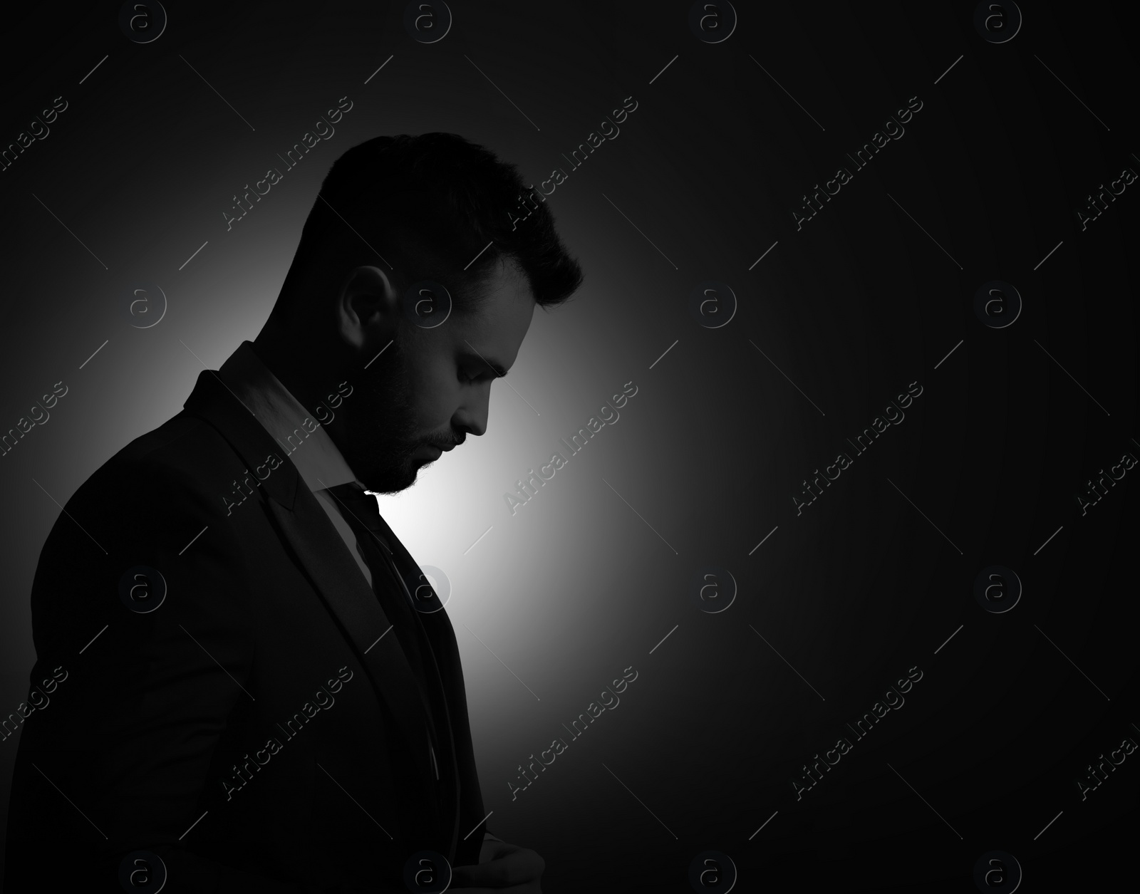 Image of Silhouette of man in darkness. Portrait on black background