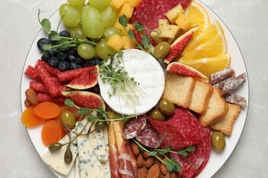 Set of different delicious appetizers served on light grey table, top view