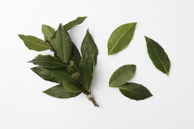 Aromatic fresh bay leaves on white background, flat lay