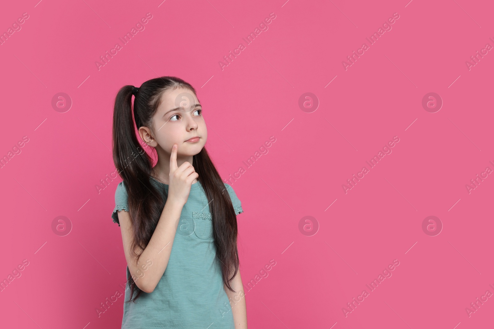 Photo of Pensive little girl on pink background, space for text. Thinking about answer to question