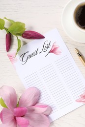 Guest list, coffee, pen and beautiful flowers on white wooden table, flat lay. Space for text