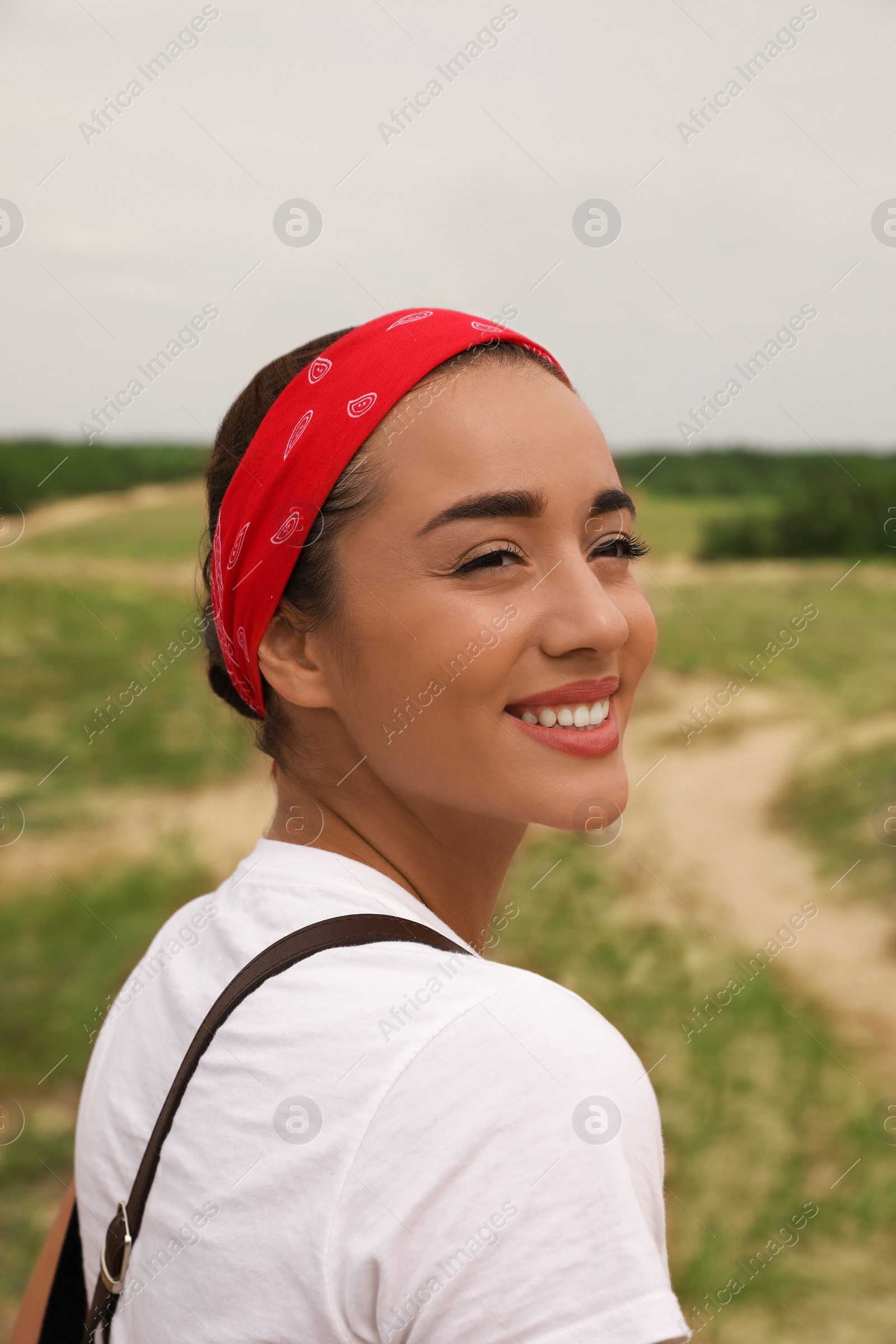 Photo of Portrait of beautiful young woman smiling outdoors