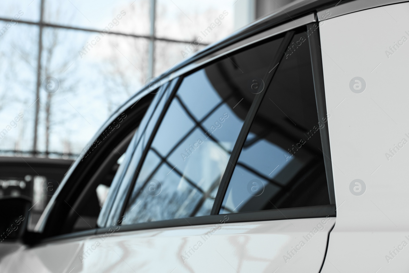 Photo of Modern car with tinting foil on window, closeup