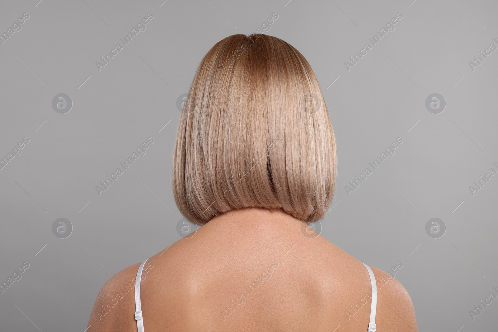 Photo of Beautiful woman with healthy skin on grey background, back view