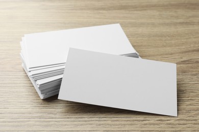 Photo of Blank business cards on wooden table, closeup. Mockup for design