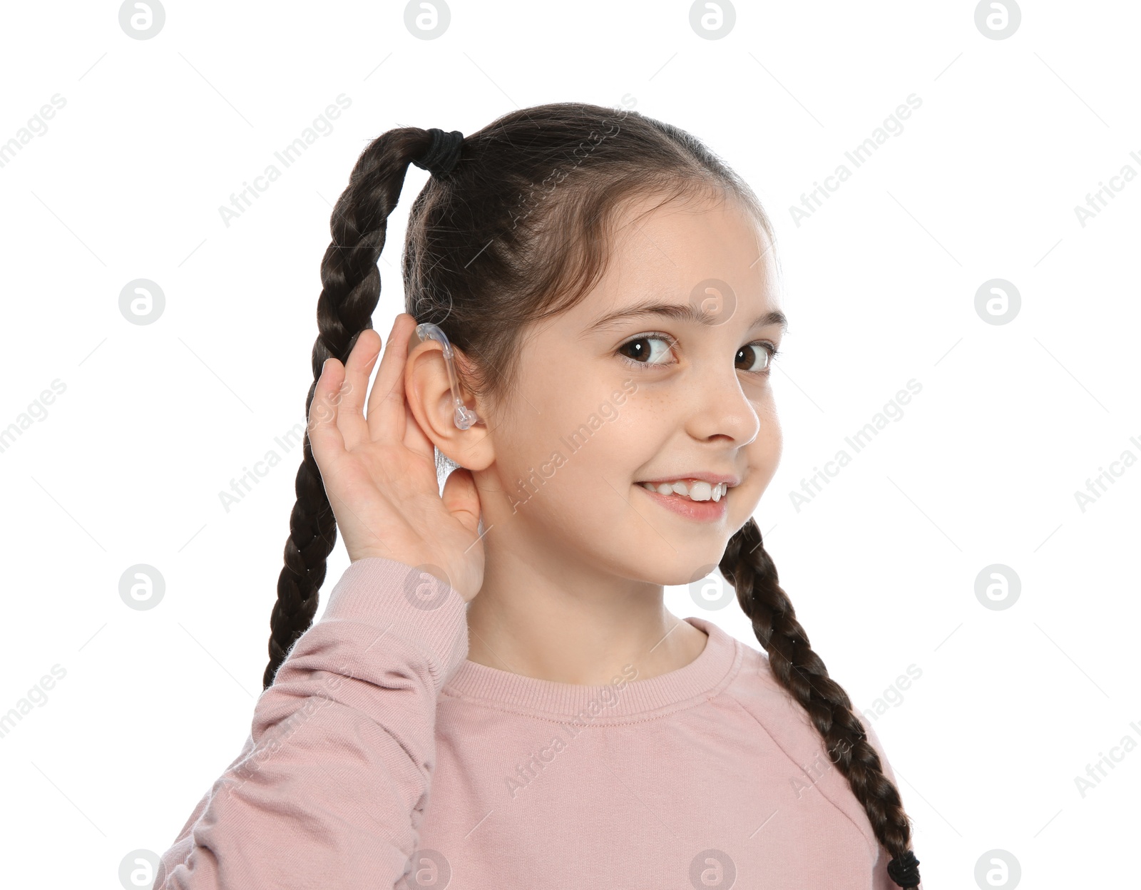 Photo of Little girl with hearing aid on white background