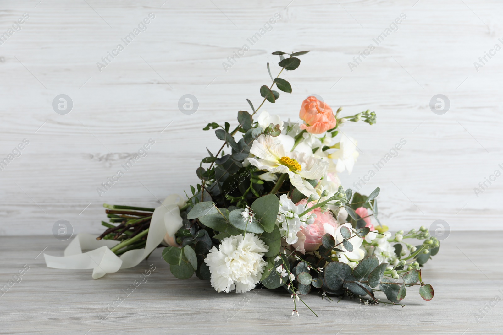 Photo of Bouquet of beautiful flowers on wooden table