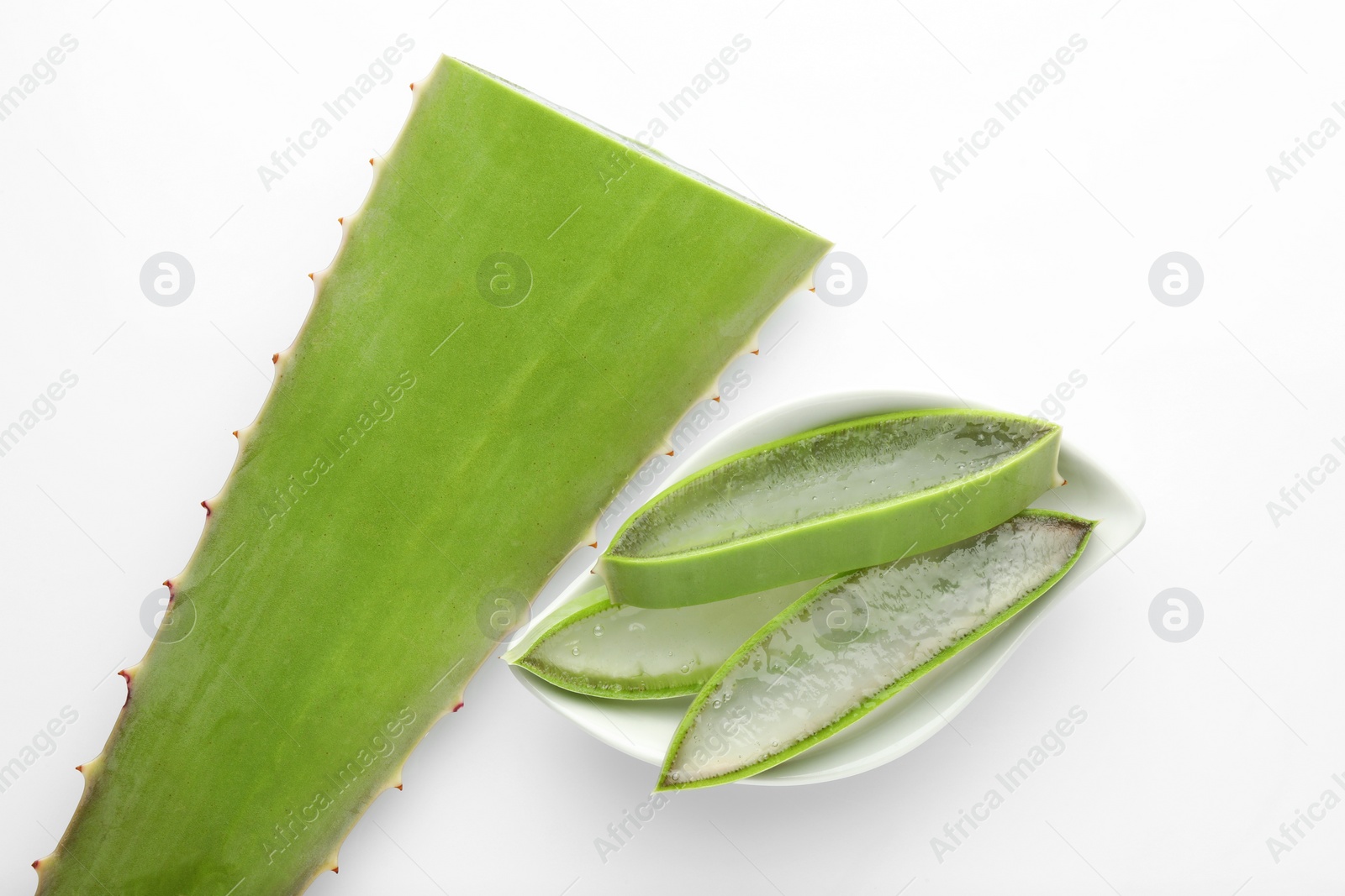 Photo of Bowl with cut aloe vera on white background, flat lay