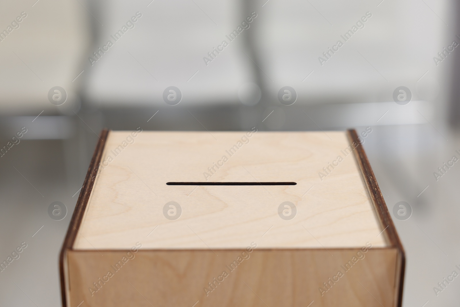 Photo of Wooden ballot box on blurred background, closeup