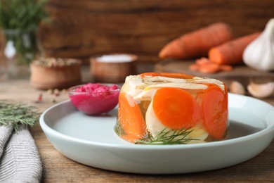 Delicious chicken aspic served on wooden table, closeup