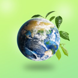 Image of Recycling concept. Earth planet with green leaves on color background