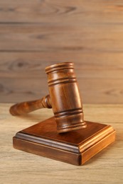 Wooden gavel and sound block on table