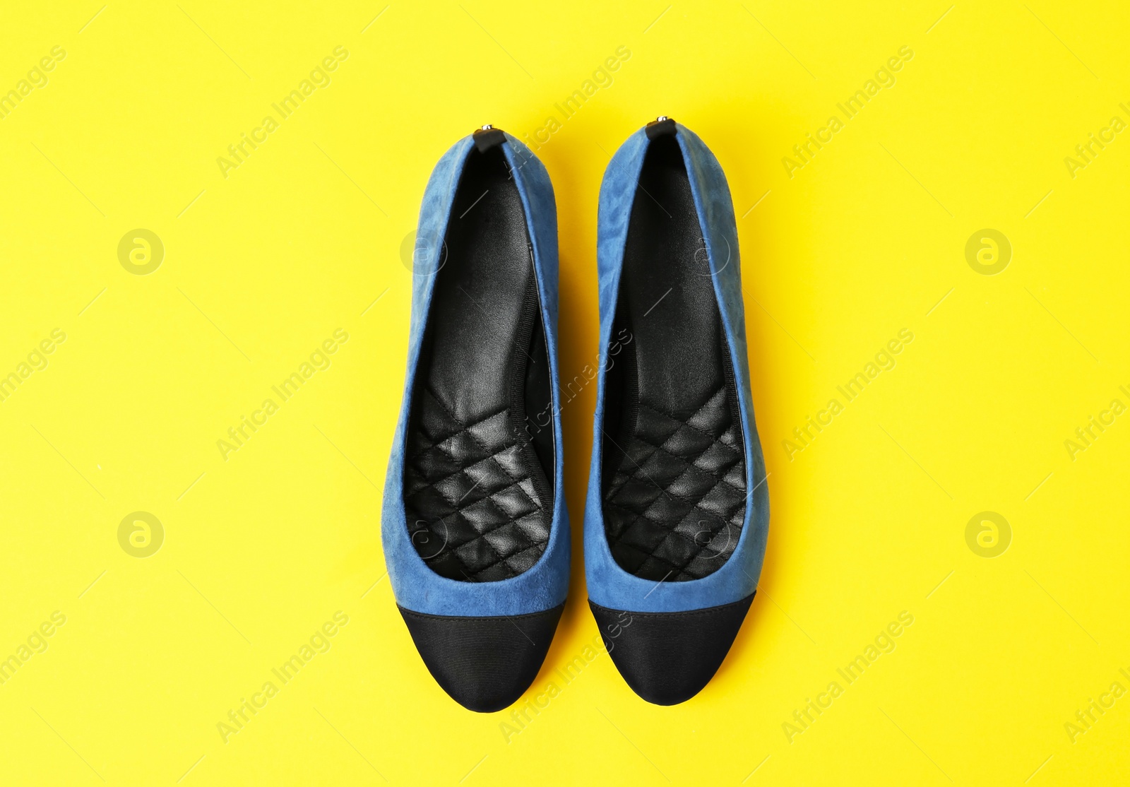 Photo of Pair of female shoes on color background, top view