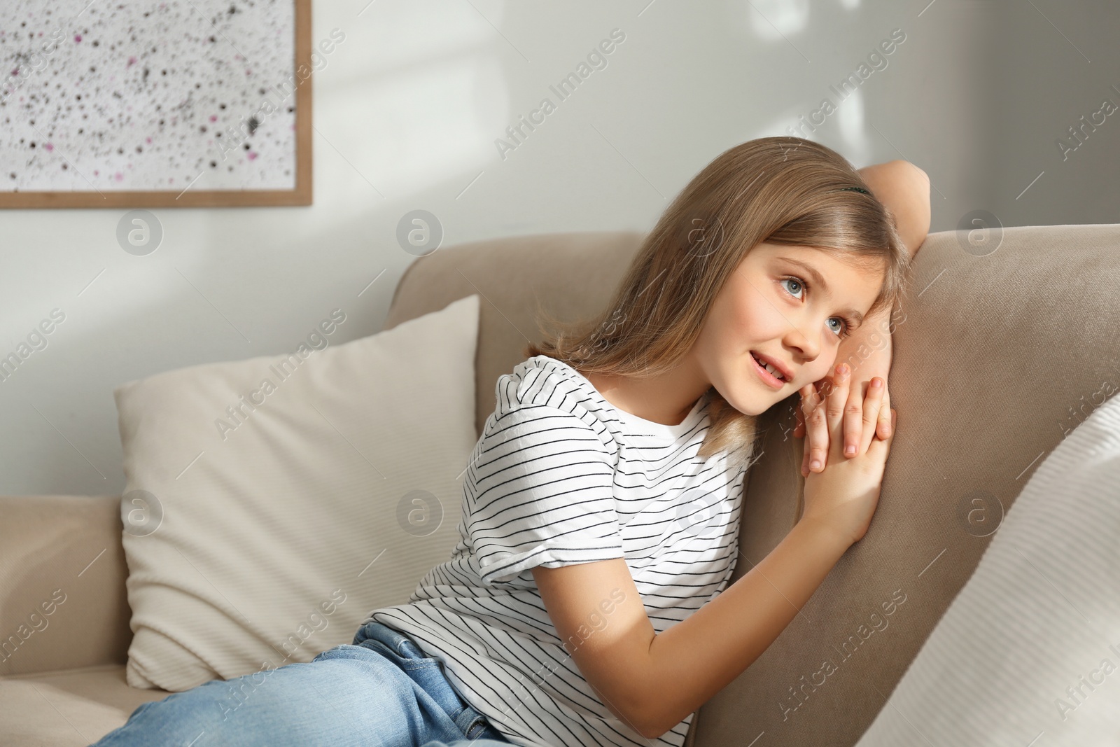 Photo of Cute little girl on couch at home