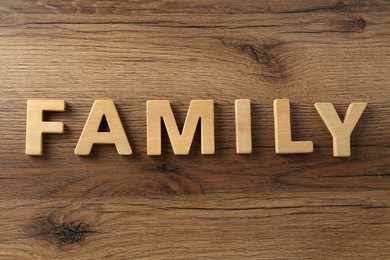 Word Family made with wooden letters on table, flat lay