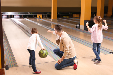 Happy family spending time together in bowling club