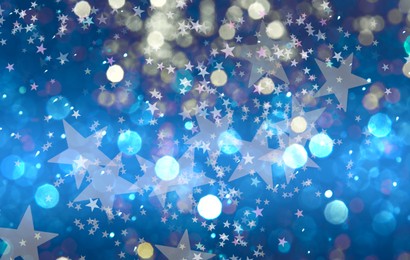 Image of Many beautiful shimmering stars and blurred lights on blue background. Bokeh effect