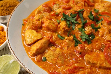 Delicious chicken curry with parsley on table, closeup