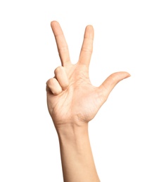 Photo of Woman showing number three on white background, closeup. Sign language