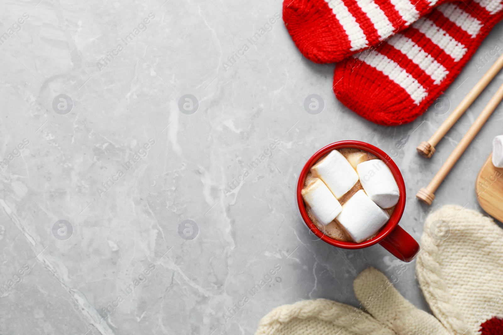 Photo of Flat lay composition with cup of tasty cocoa on grey marble table, space for text. Cozy winter