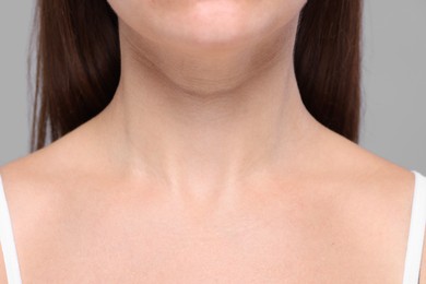 Photo of Closeup view of woman with normal skin on grey background