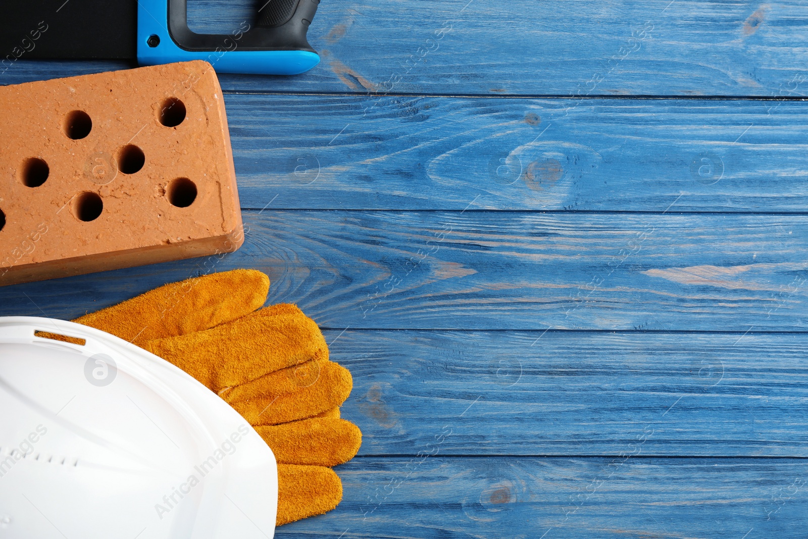 Photo of Flat lay composition with different construction tools and space for text on color wooden background