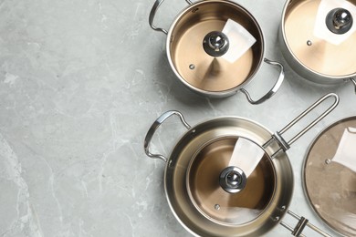 Photo of New cookware set on grey table, flat lay. Space for text