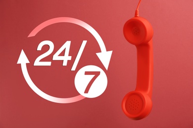 Image of 24/7 hotline service. Handset on red background