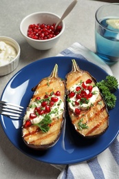 Photo of Plate with tasty fried eggplants on gray table