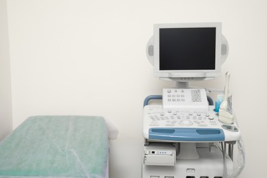 Photo of Ultrasound machine and examination table in hospital