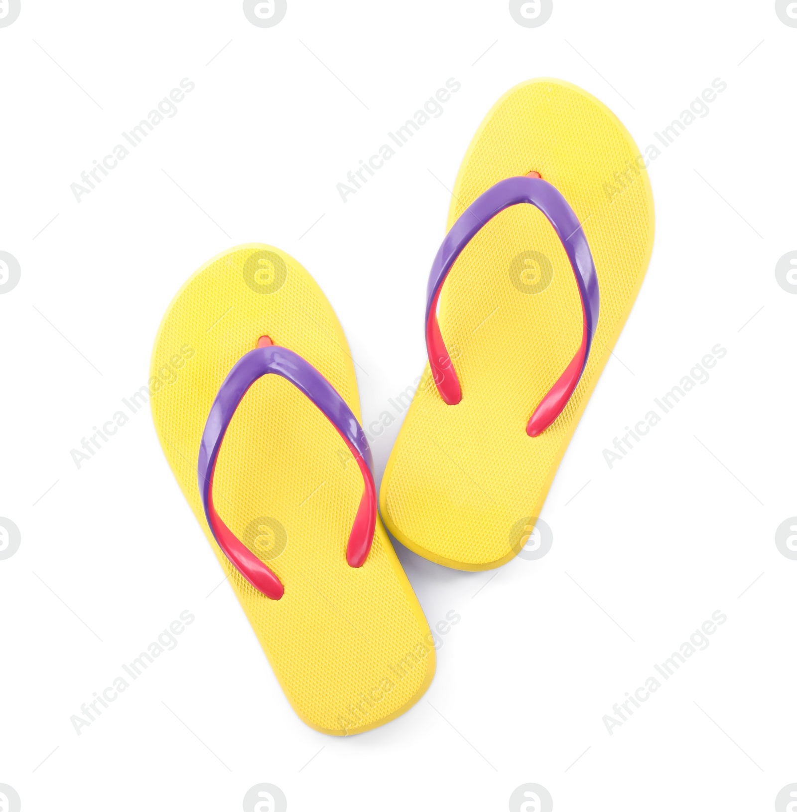 Photo of Pair of stylish yellow flip flops isolated on white, top view. Beach object