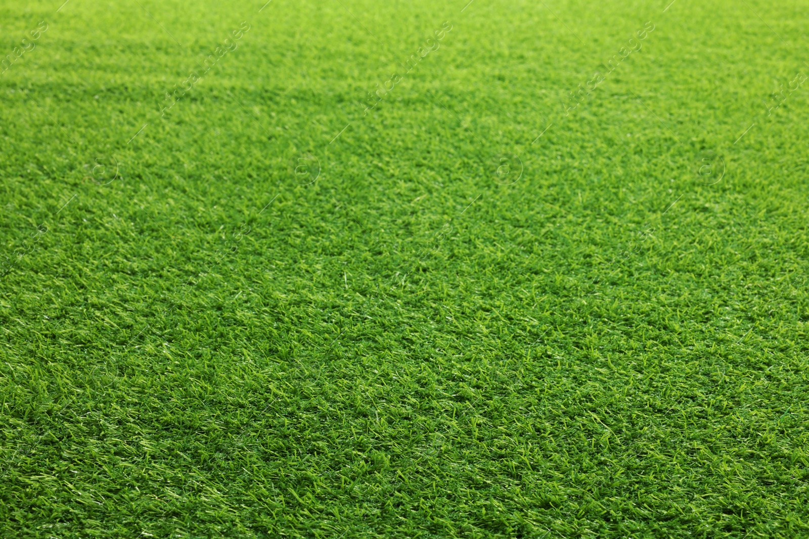 Photo of Green artificial grass as background, closeup view