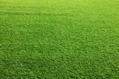 Photo of Green artificial grass as background, closeup view