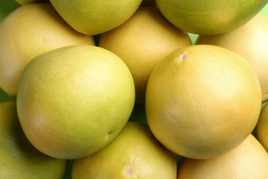 Fresh pomelo fruits as background, closeup view