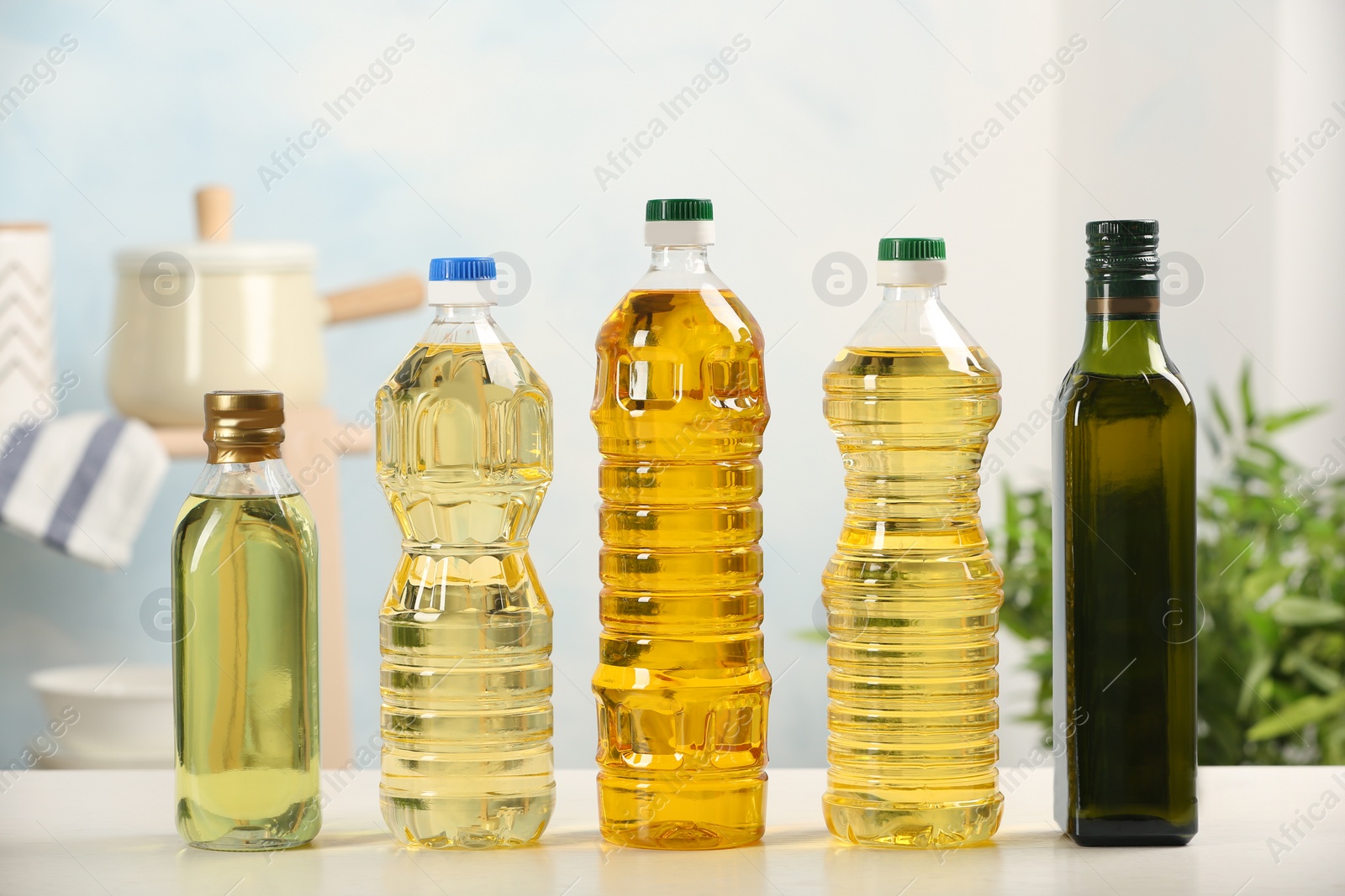 Photo of Bottles of oils on table against blurred background