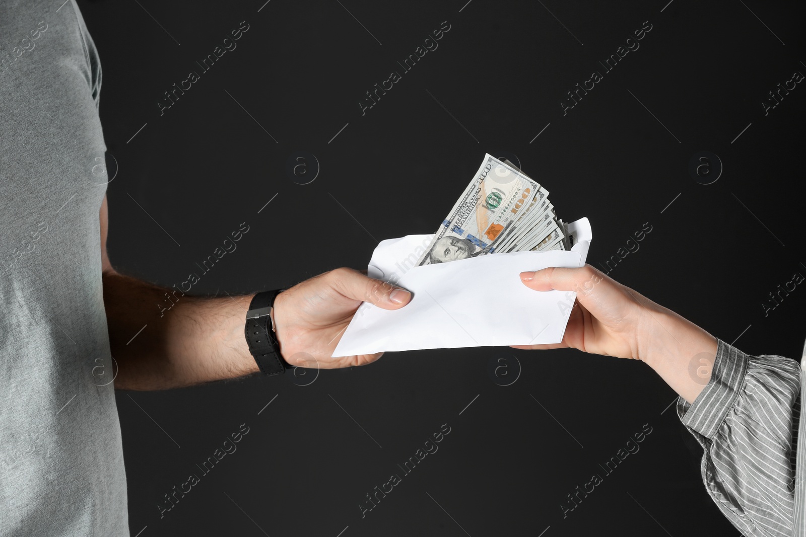 Photo of Woman giving bribe money to man on black background, closeup