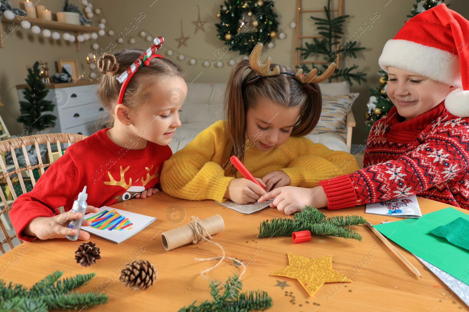 Photo of Cute little children making beautiful Christmas greeting cards at home