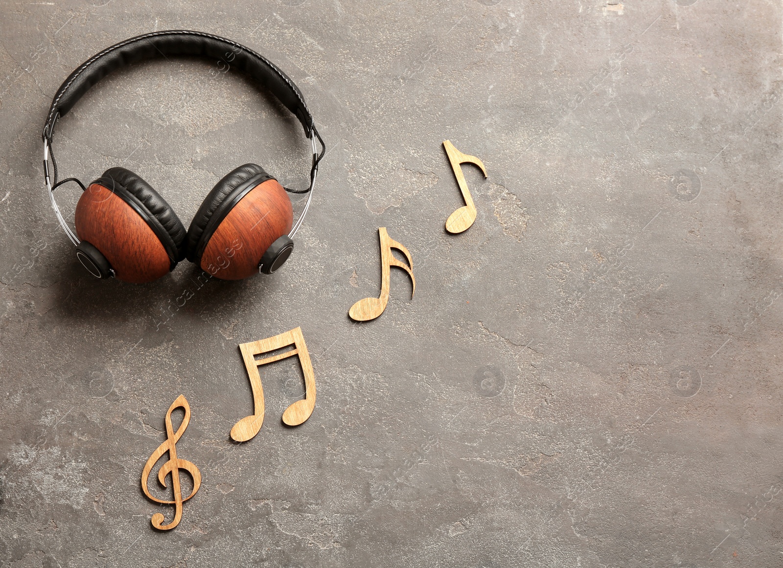 Photo of Flat lay composition with music notes, headphones and space for text on color background