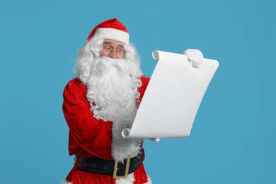 Merry Christmas. Santa Claus reading wishlist on light blue background
