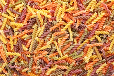 Uncooked fusilli pasta as background, closeup