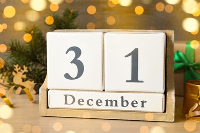 Wooden block calendar and Christmas decor on table. Holiday countdown