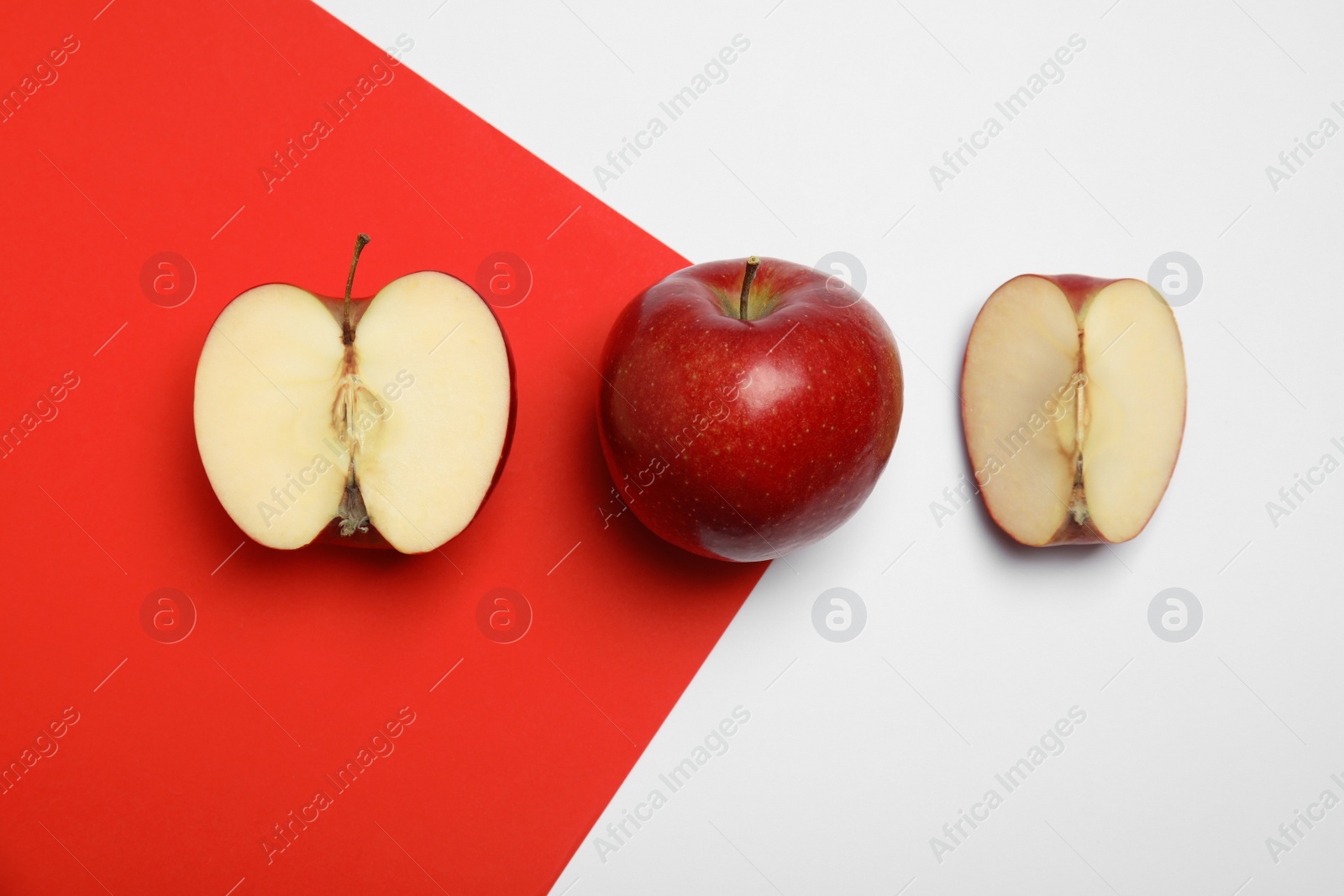 Photo of Flat lay composition with ripe juicy red apples on color background