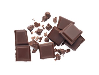 Pieces of delicious dark chocolate bar on white background, top view