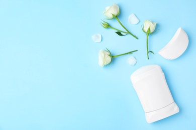 Flat lay composition with natural female deodorant on light blue background, space for text