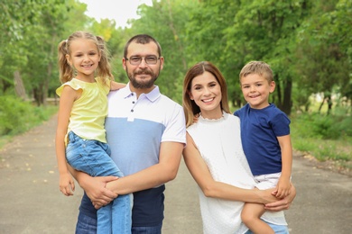 Photo of Happy family spending time together with their children outdoors