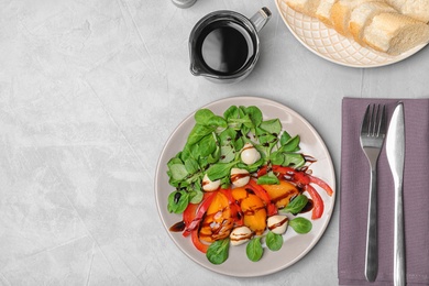 Photo of Vegetable salad served with balsamic vinegar on grey background, top view. Space for text