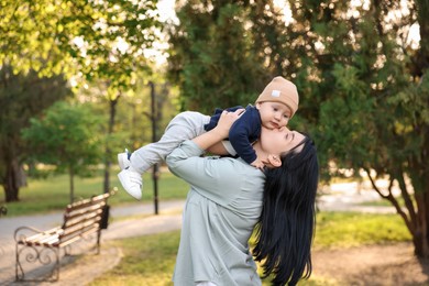 Happy mother having fun with her baby in park