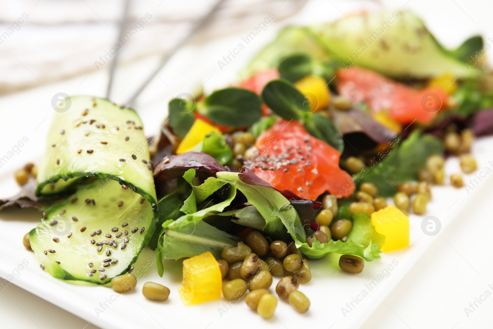 Photo of Plate of salad with mung beans on white table, closeup