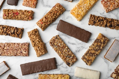 Photo of Flat lay composition with protein bars on marble background